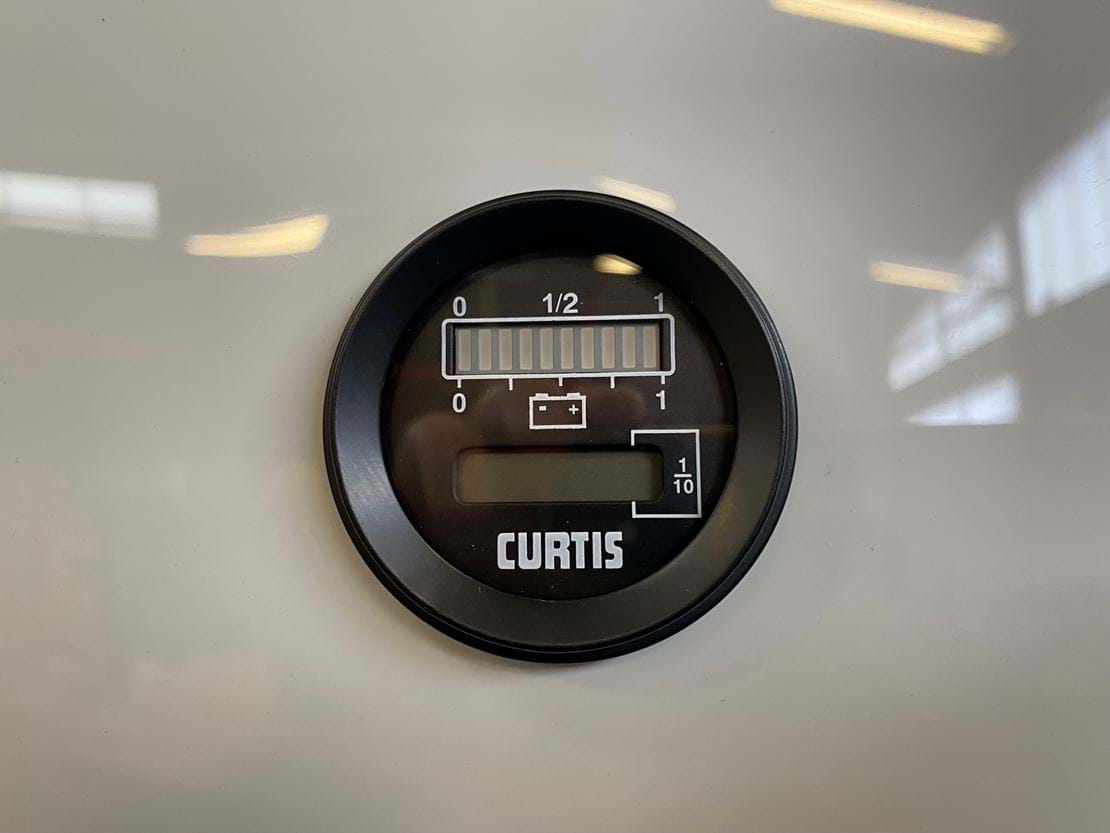 Battery Discharge Indicator And Hour Meter